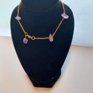 Bracelet fabriqué avec une chaîne fine dorée en acier inoxydable et des pierres semi-précieuses d'Améthyste.